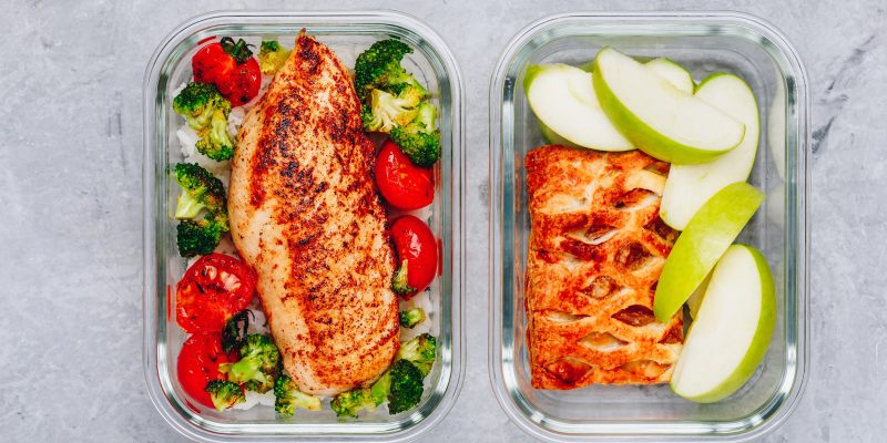Grilled chicken meal prep containers with rice, broccoli and tomatoes and dessert pie with green apple.
